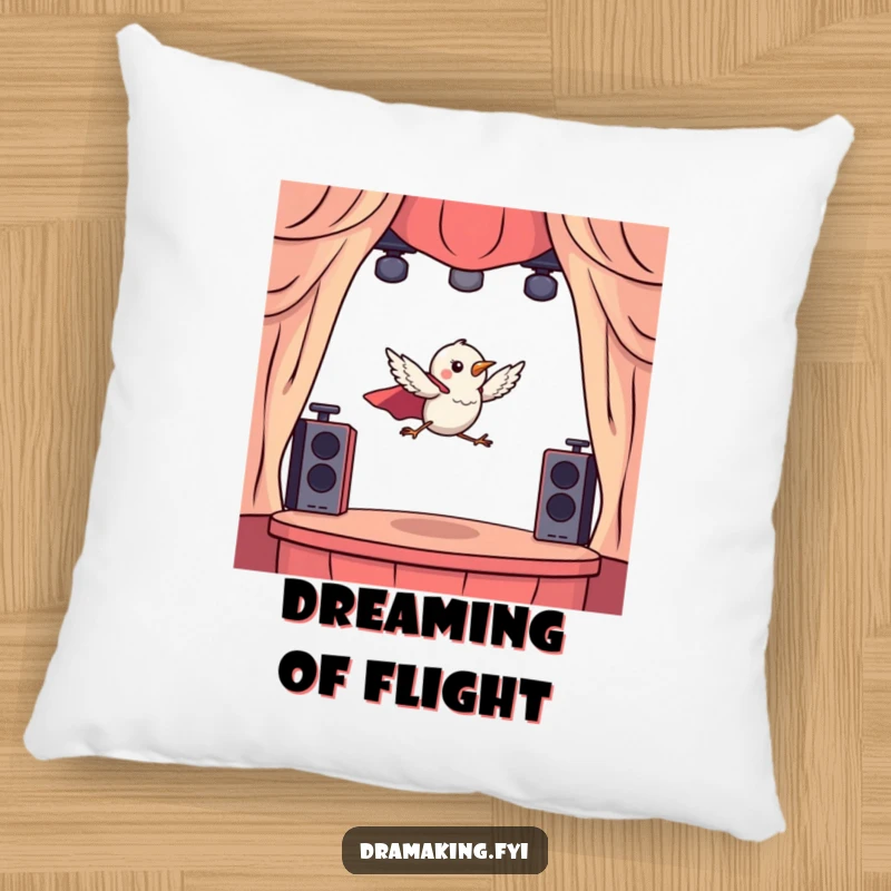 Funny pillow with a tiny bird wearing a cape, dramatically leaping from a miniature stage, for cozy, dramatic comfort.