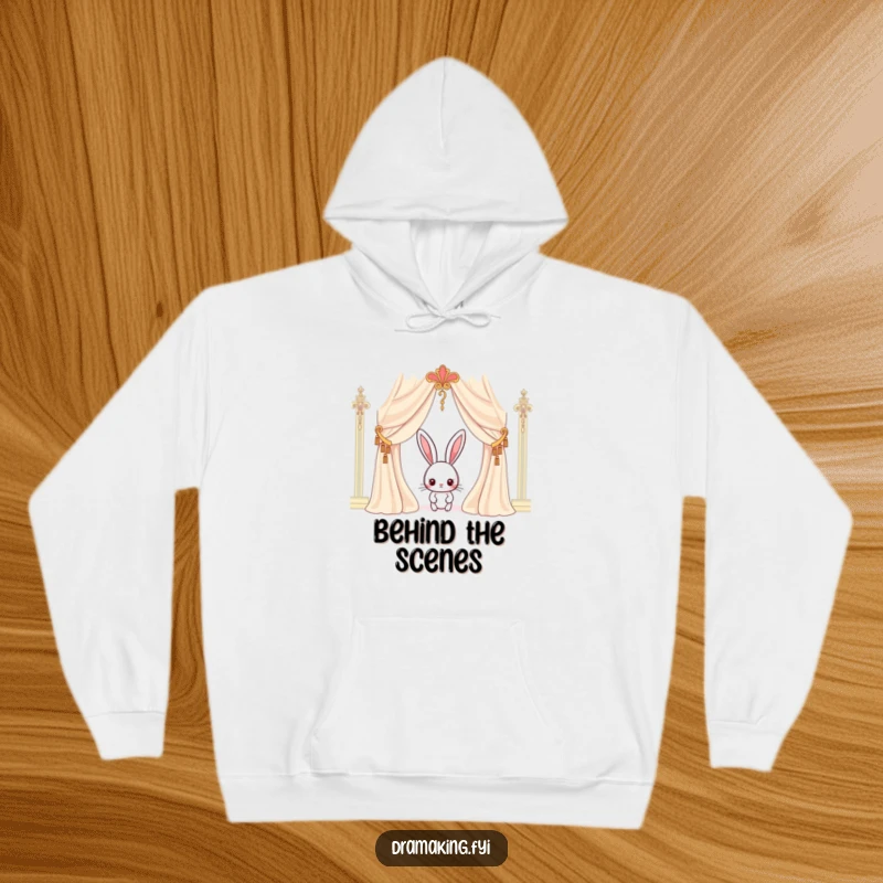Funny rabbit hoodie featuring a curious character peeking behind an ornate curtain, symbolizing anticipation and cozy comfort.