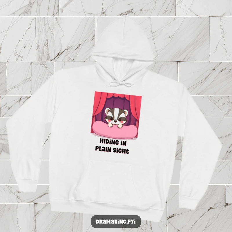 Funny Shy Badger Stage Hoodie featuring a bashful badger peeking from behind a cushion, preparing for a hilariously grand performance.
