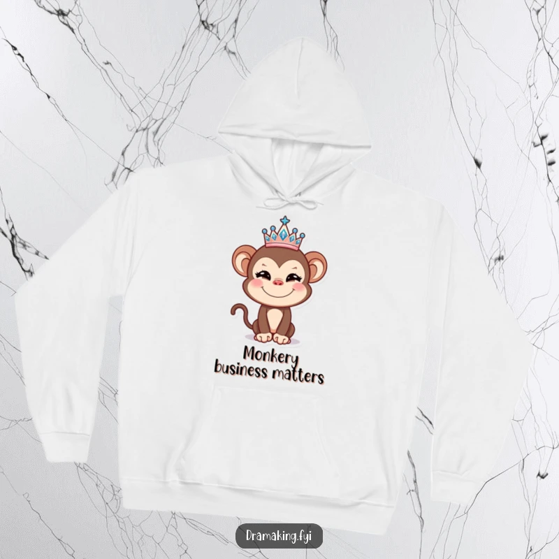 Funny Monkey Hoodie showcasing a mischievous monkey balancing a glittery tiara, offering a blend of comfort and comedic royalty.