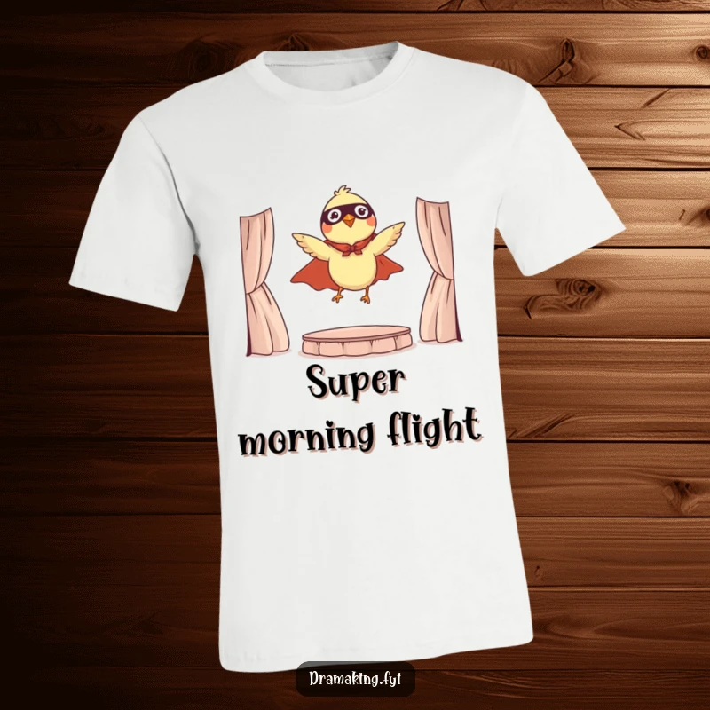 Funny t-shirt depicting a tiny bird wearing a cape, dramatically leaping from a miniature stage, a symbol of courage.